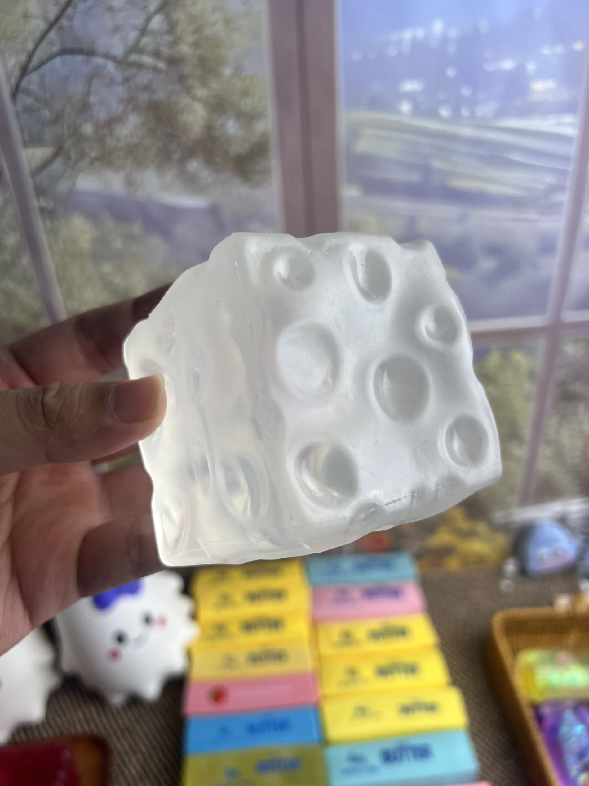 White cheese squishy held in hand